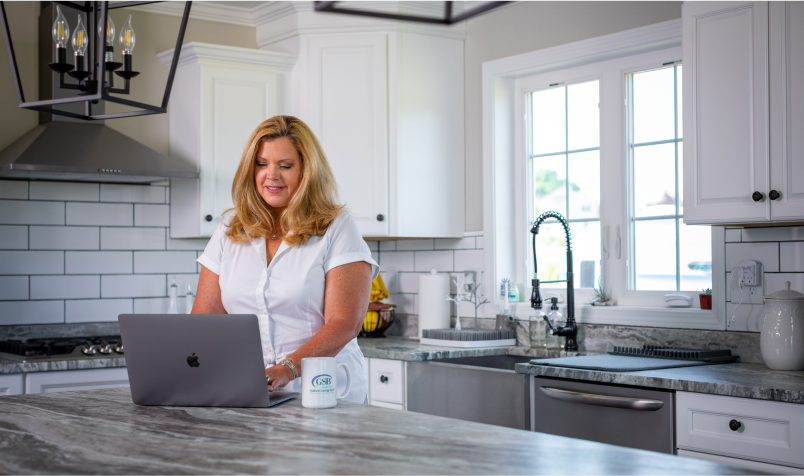 Woman on Laptop in Kitchen