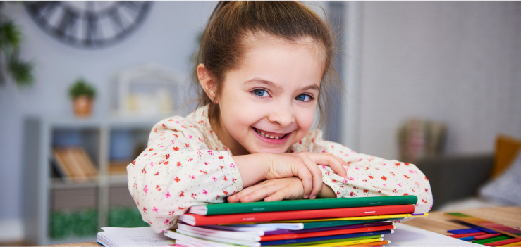 Child Smiling with Coloring Books