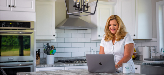 Woman on Laptop in Kitchen