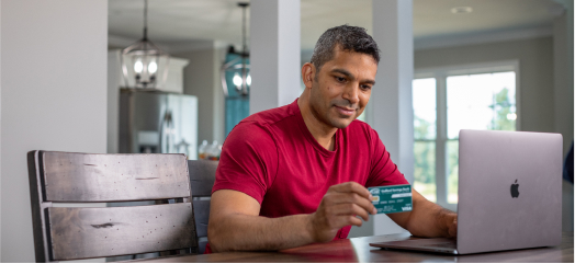 Man with credit card at computer