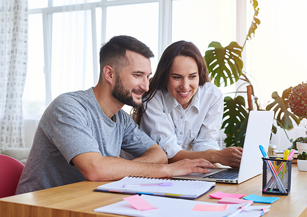 Couple working on Laptop at home