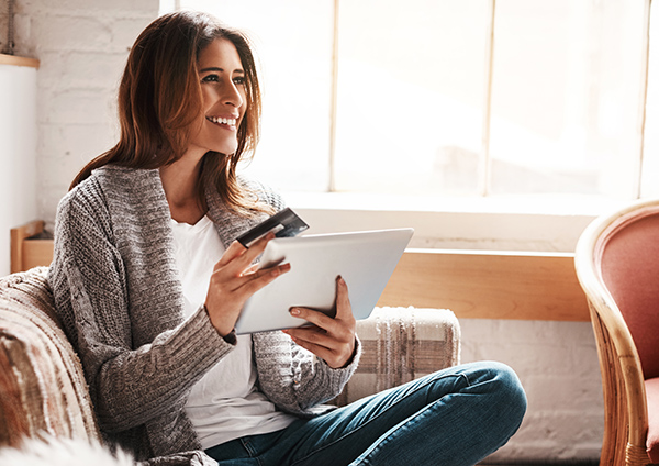 Woman sitting on chair with a credit card