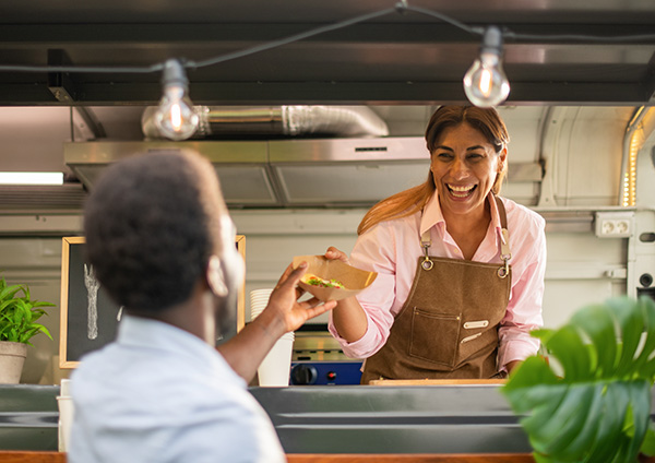 Food truck vendor handing food out