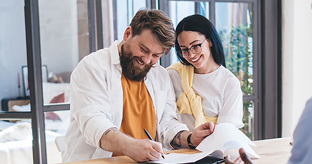 Couple signing new mortgage contract