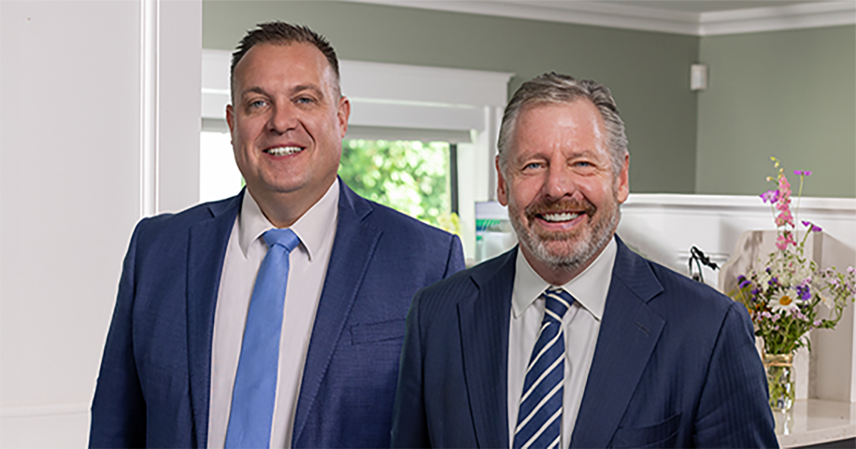 CEO Kyle Eagleson standing next to former CEO Tim Geelan