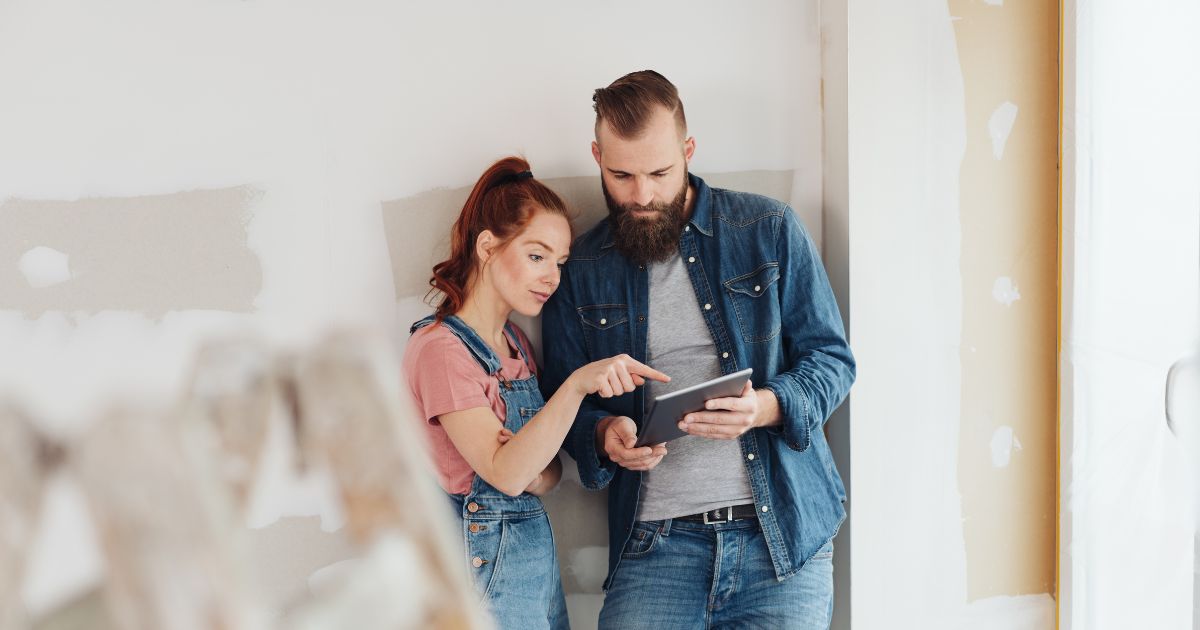 Couple using tablet in the middle of a home renovation project